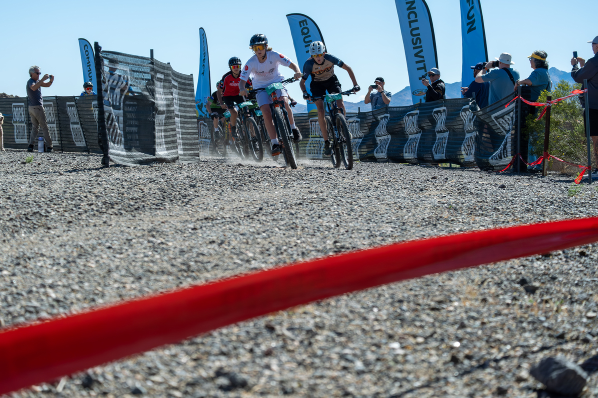 Student athletes racing away from the start line looking intently at the course ahead